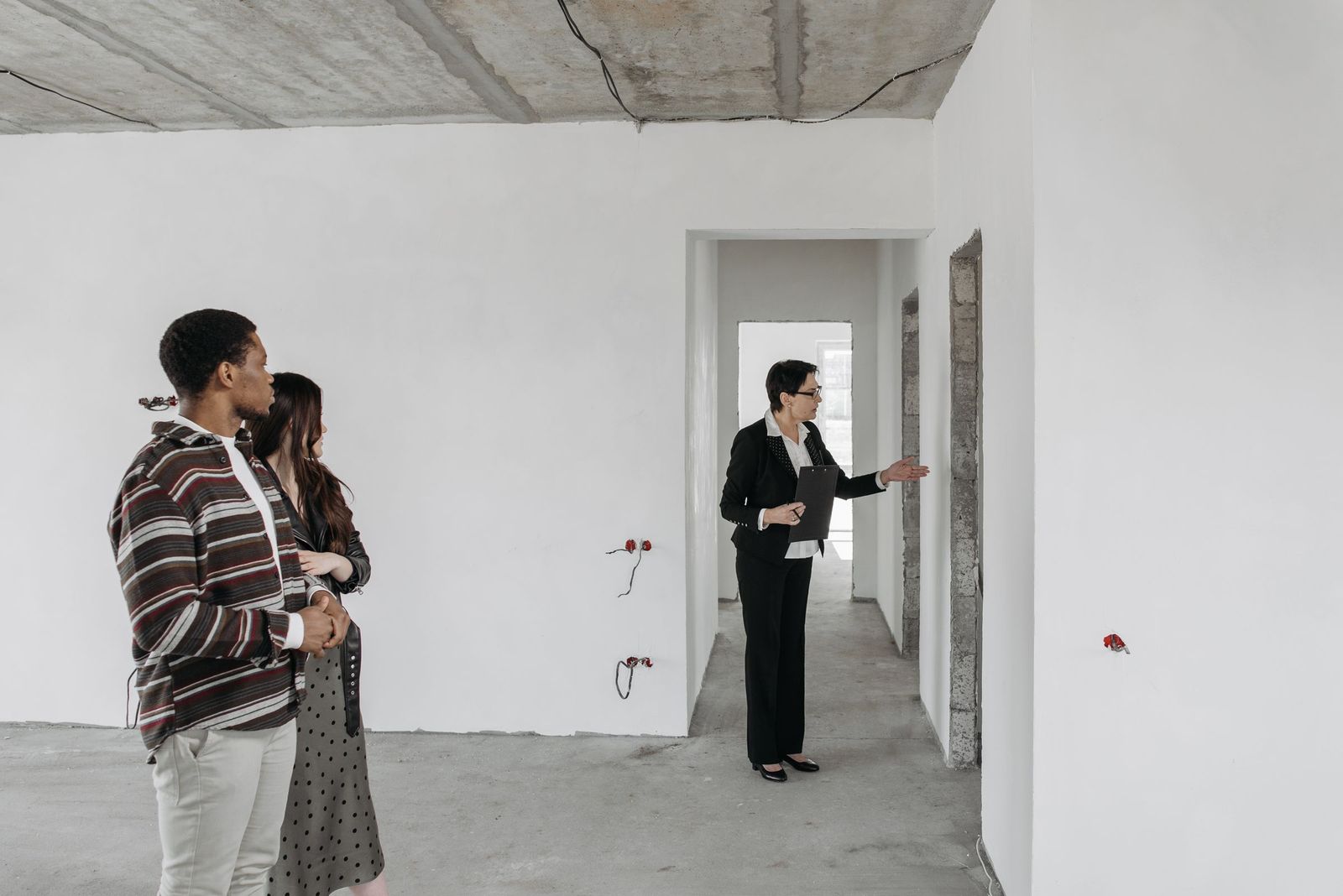 Couple touring a model home with a guide